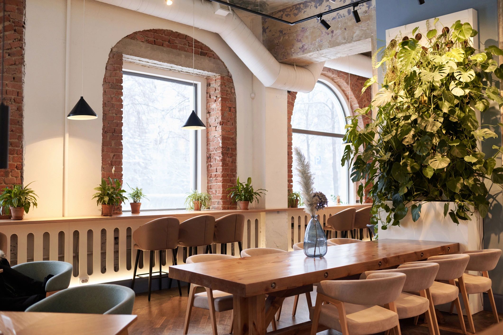 Modern upscale restaurant interior with wooden tables and plants