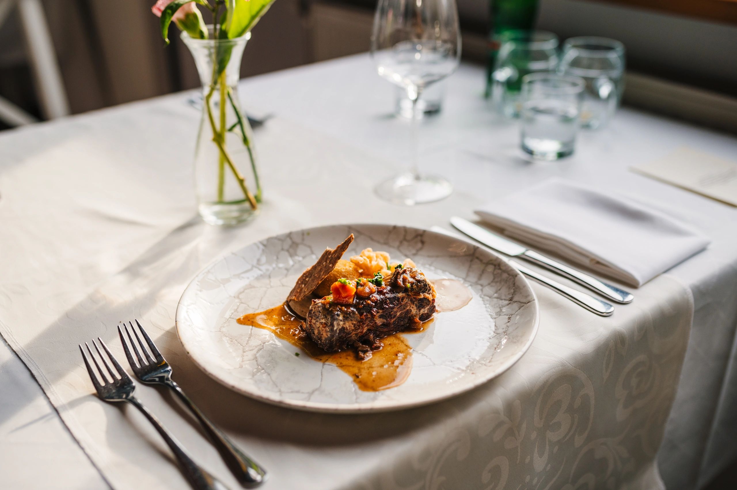Fine dining plated dish on a dark table setting